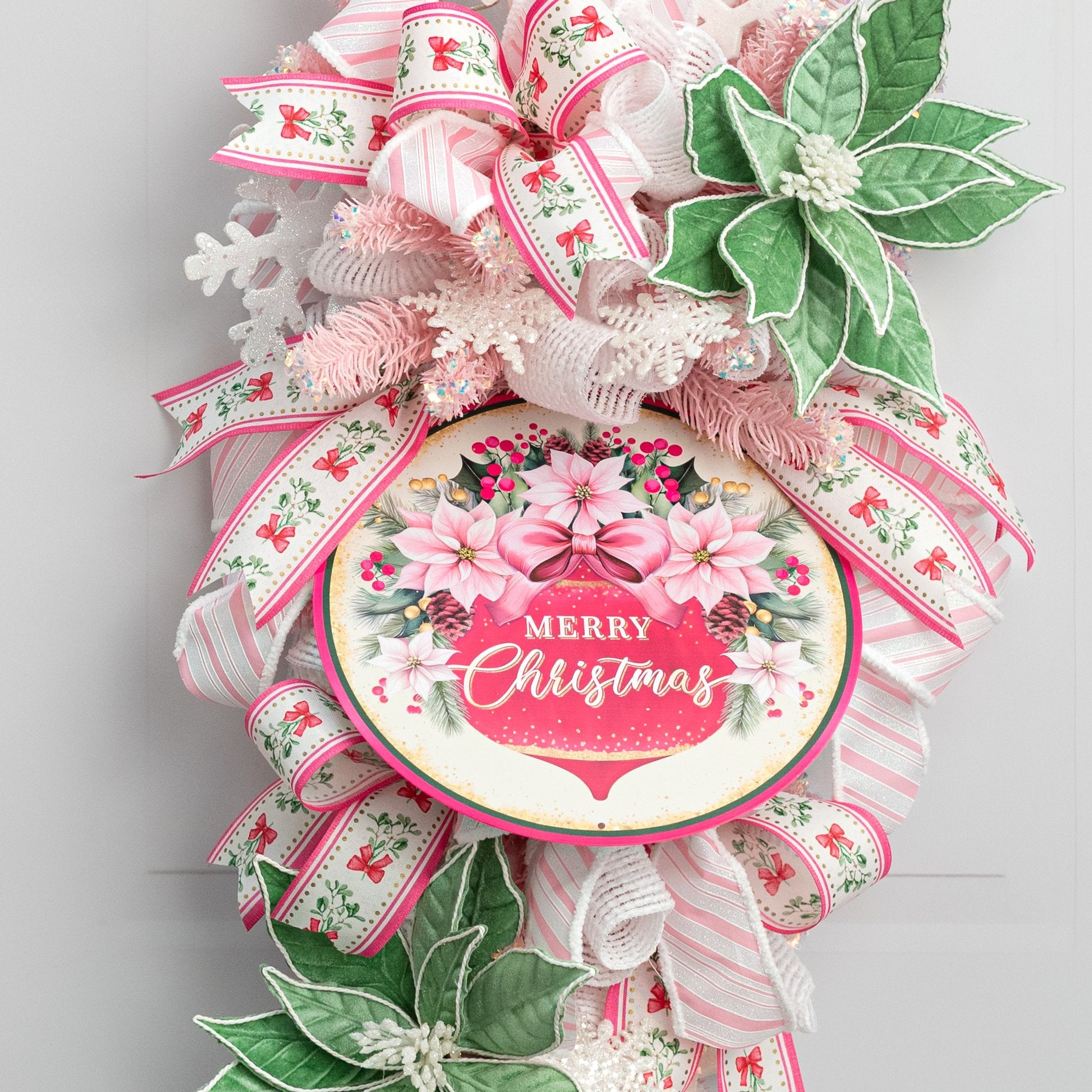 12" Round Metal Sign: Merry Christmas Ornament & Pink Poinsettias Lifestyle Photo
