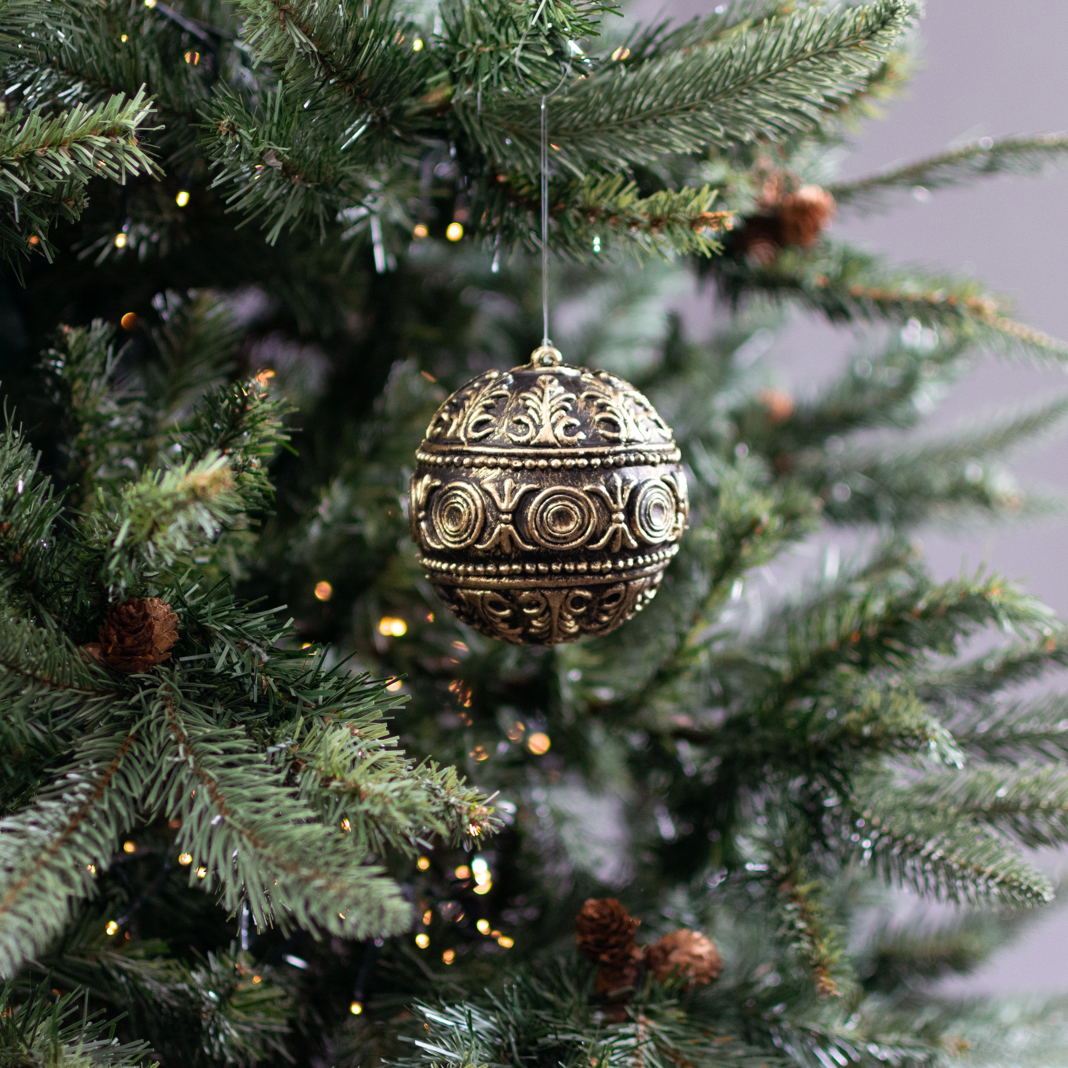 4" Antiqued Plastic Ball Ornament: Black & Gold Lifestyle Photo
