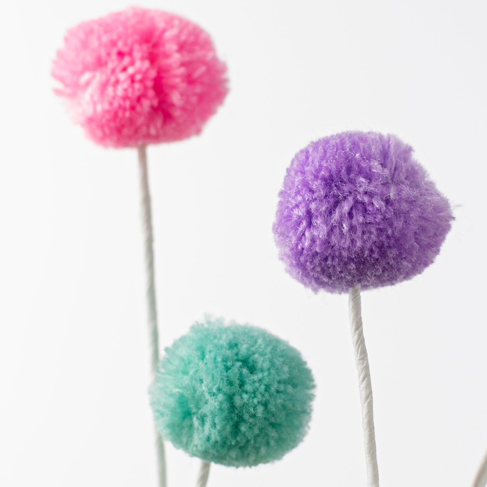 23" 4-Color Pom Pom Spray: Light Teal, Pink, Yellow, Lavender Lifestyle Photo