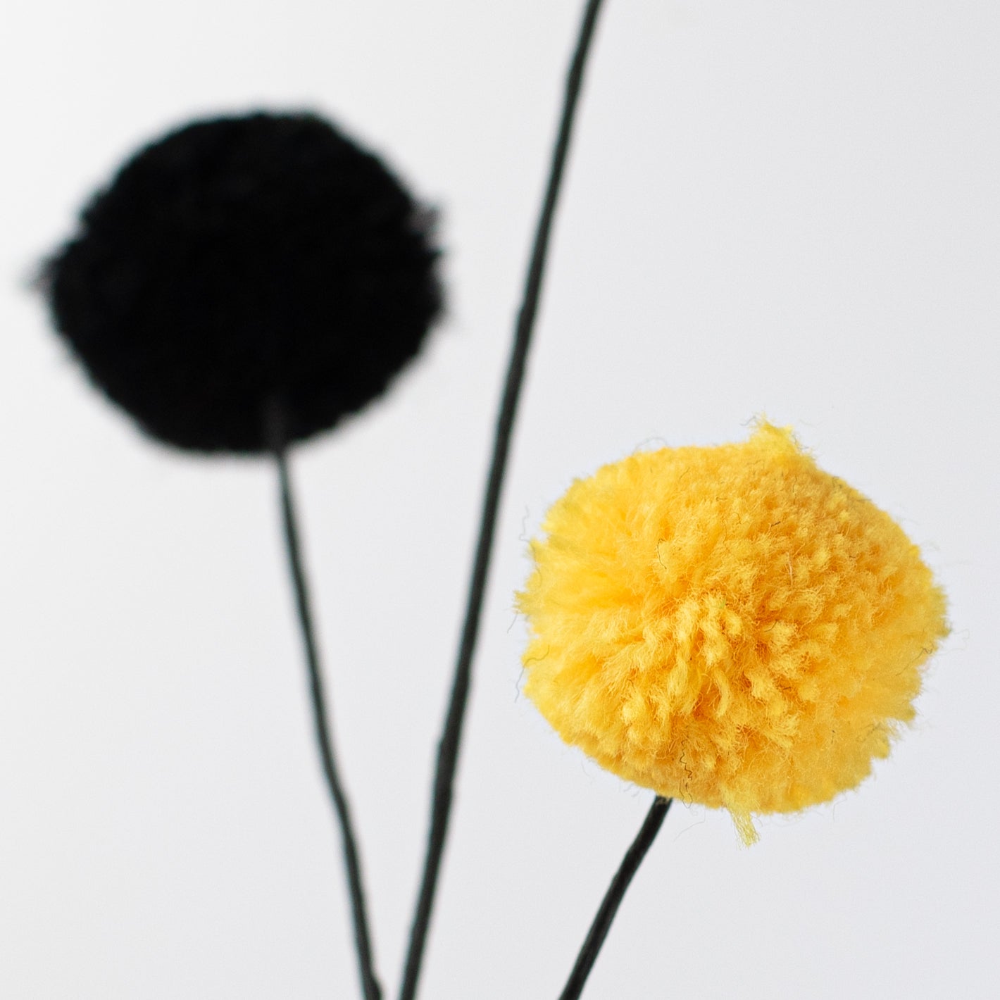 23" 2-Color Pom Pom Spray: Yellow & Black Lifestyle Photo