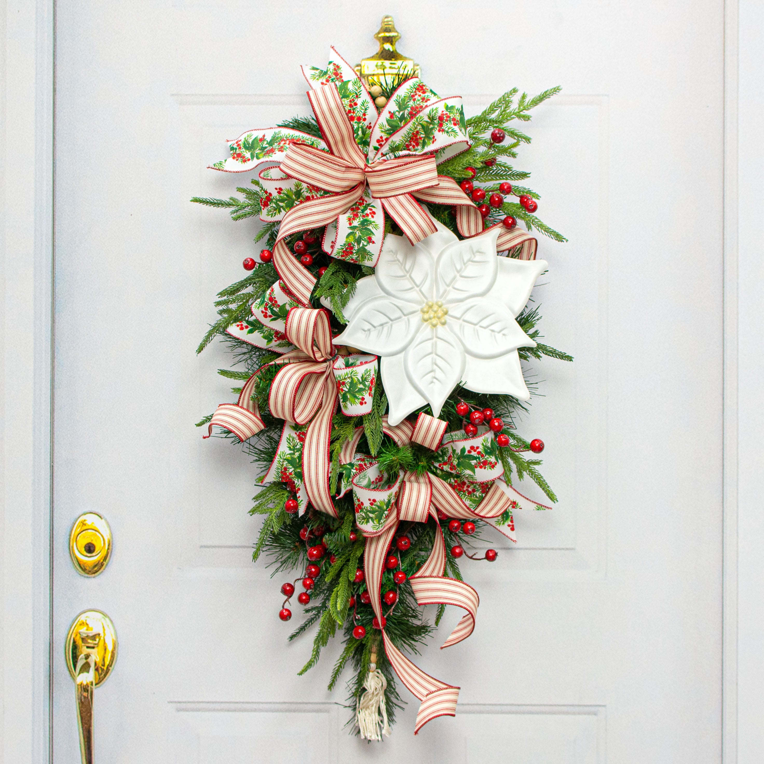 12" Embossed Metal Hanger: White Poinsettia Lifestyle Photo