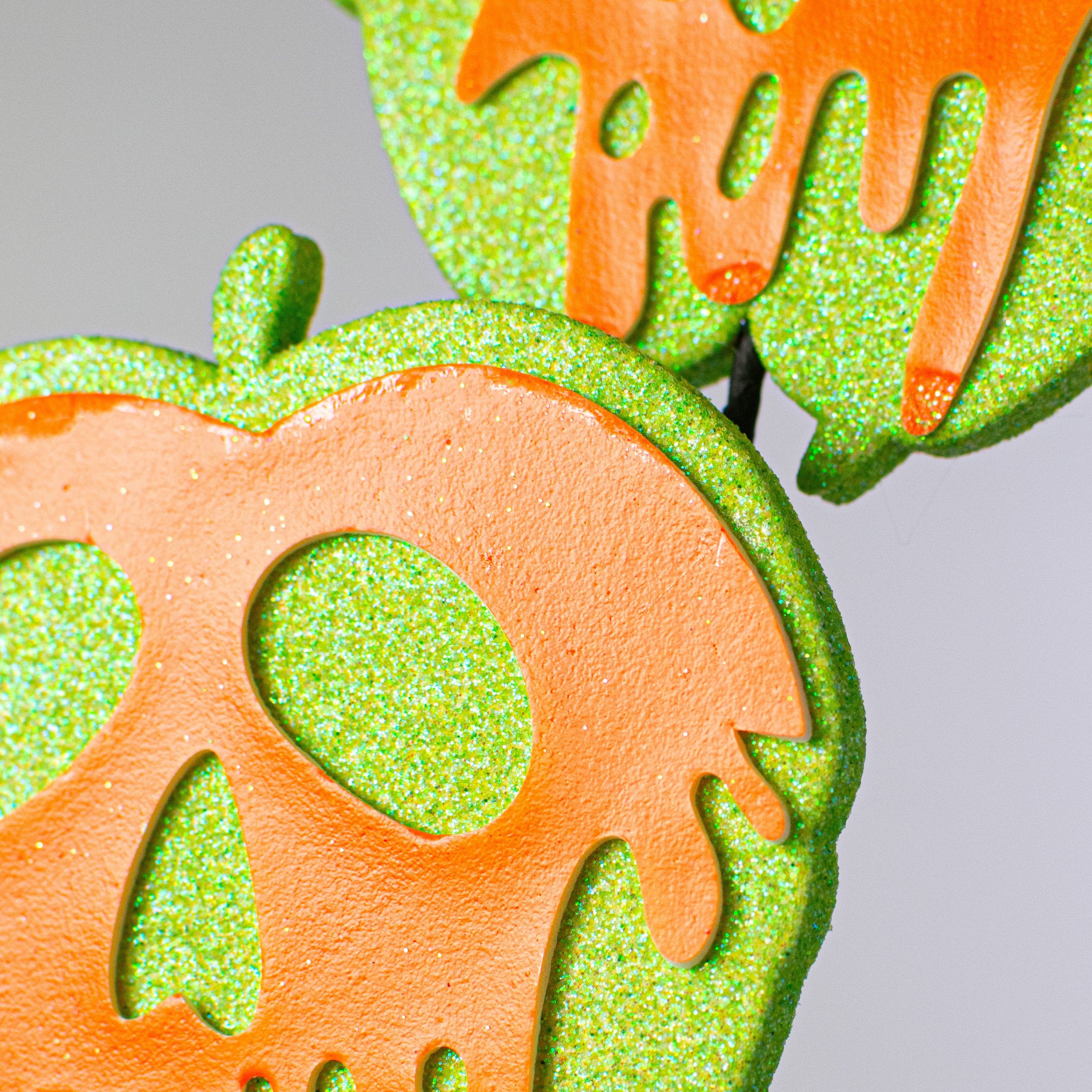 24" Glitter Poison Apple Spray: Orange & Green Lifestyle Photo