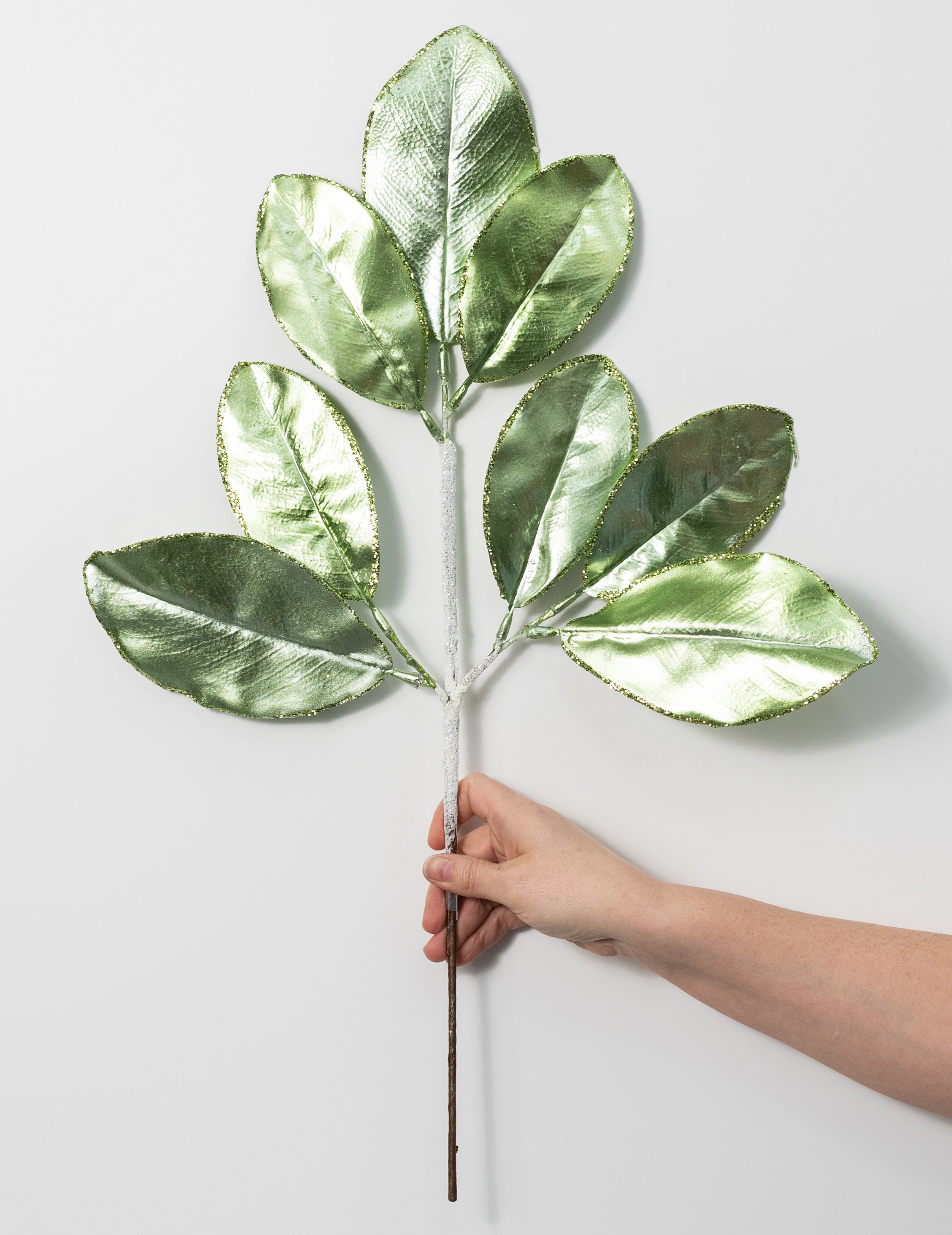 24" Metallic Magnolia Leaves Spray: Light Green