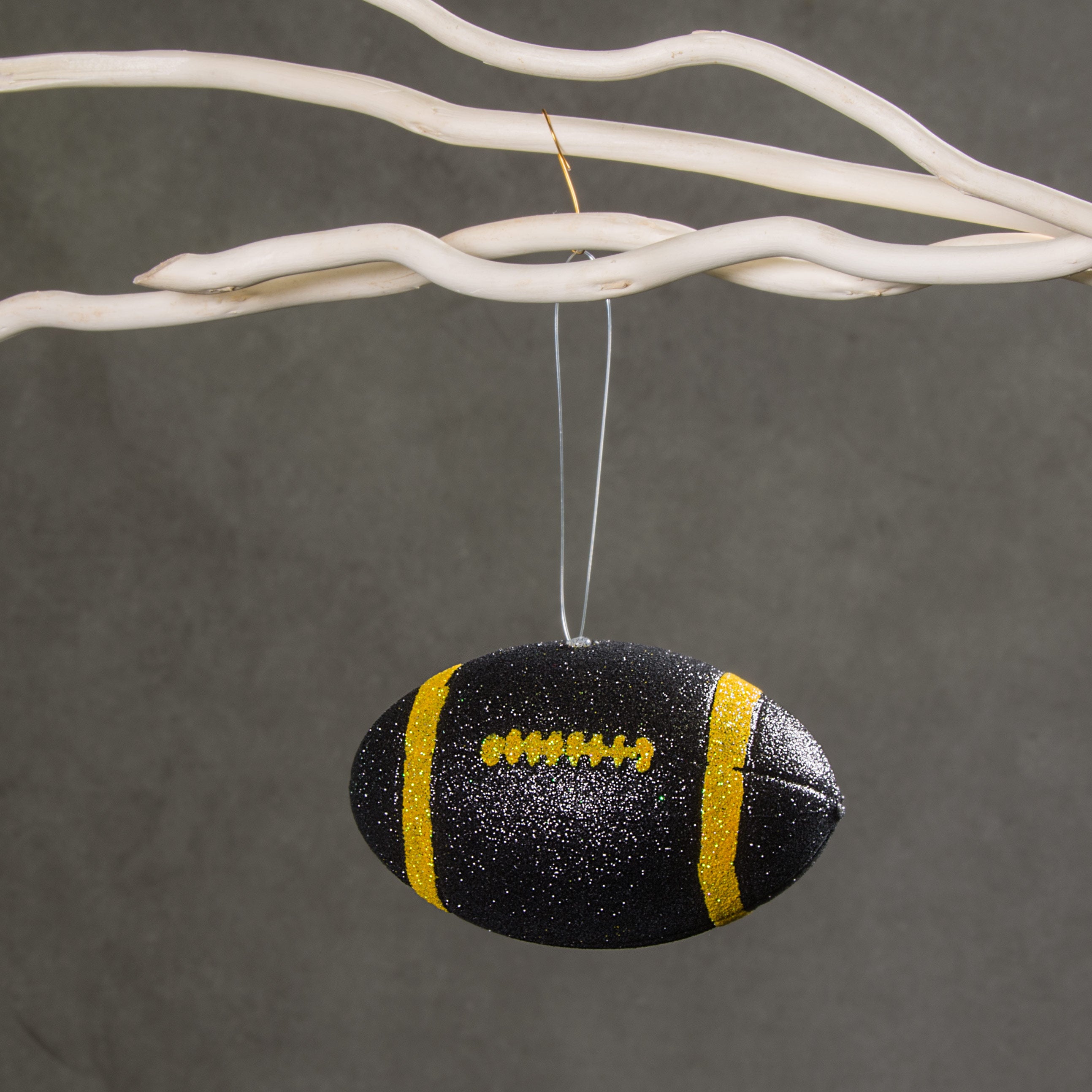 4.5" Metallic Glitter Football Ornament: Black & Yellow Lifestyle Photo