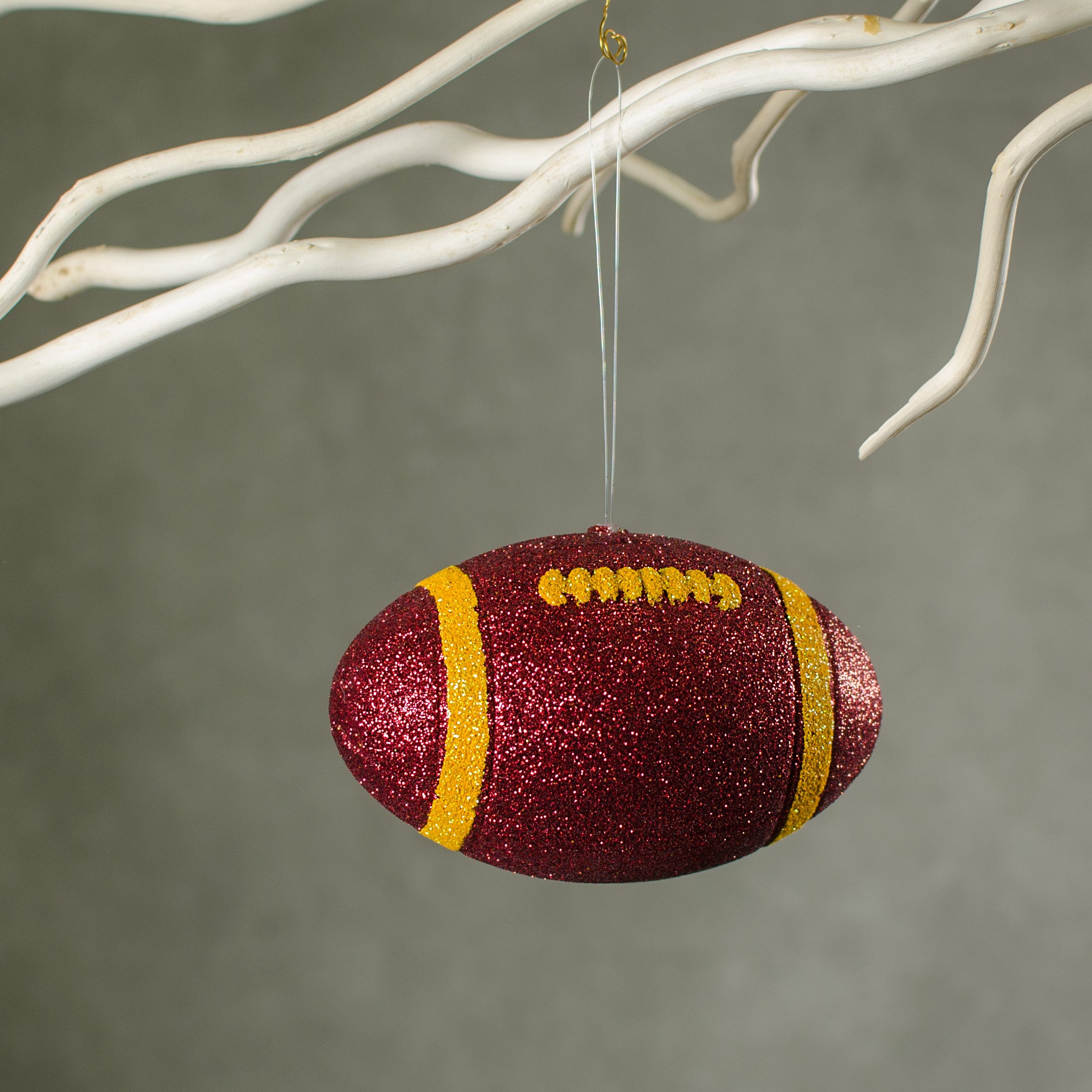 4.5" Metallic Glitter Football Ornament: Crimson Red & Yellow Lifestyle Photo