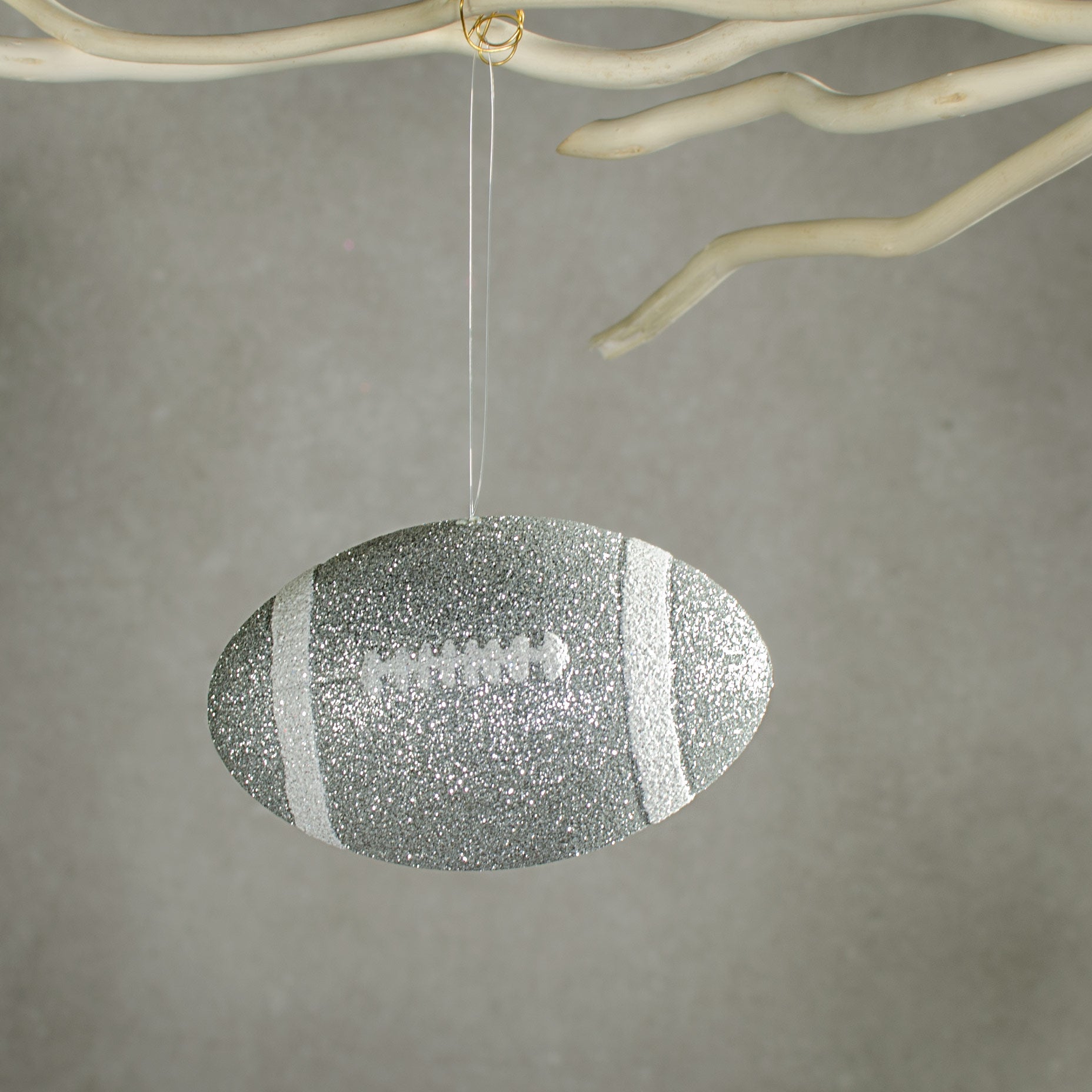 4.5" Metallic Glitter Football Ornament: Silver & White Lifestyle Photo