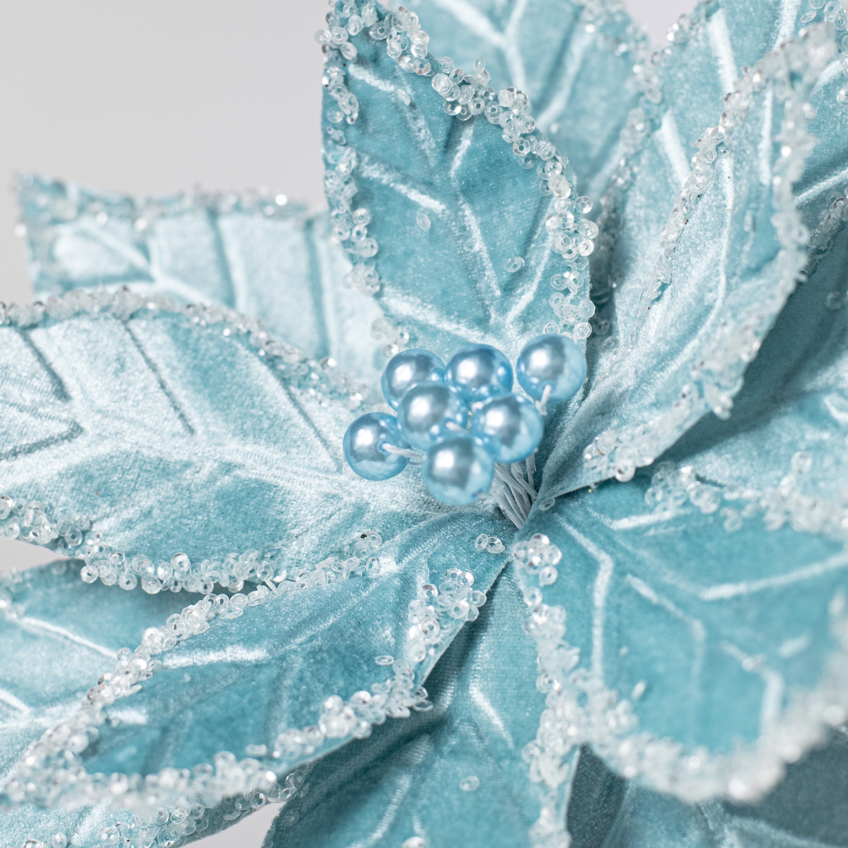 22" Velvet Poinsettia Stem: Light Blue Lifestyle Photo