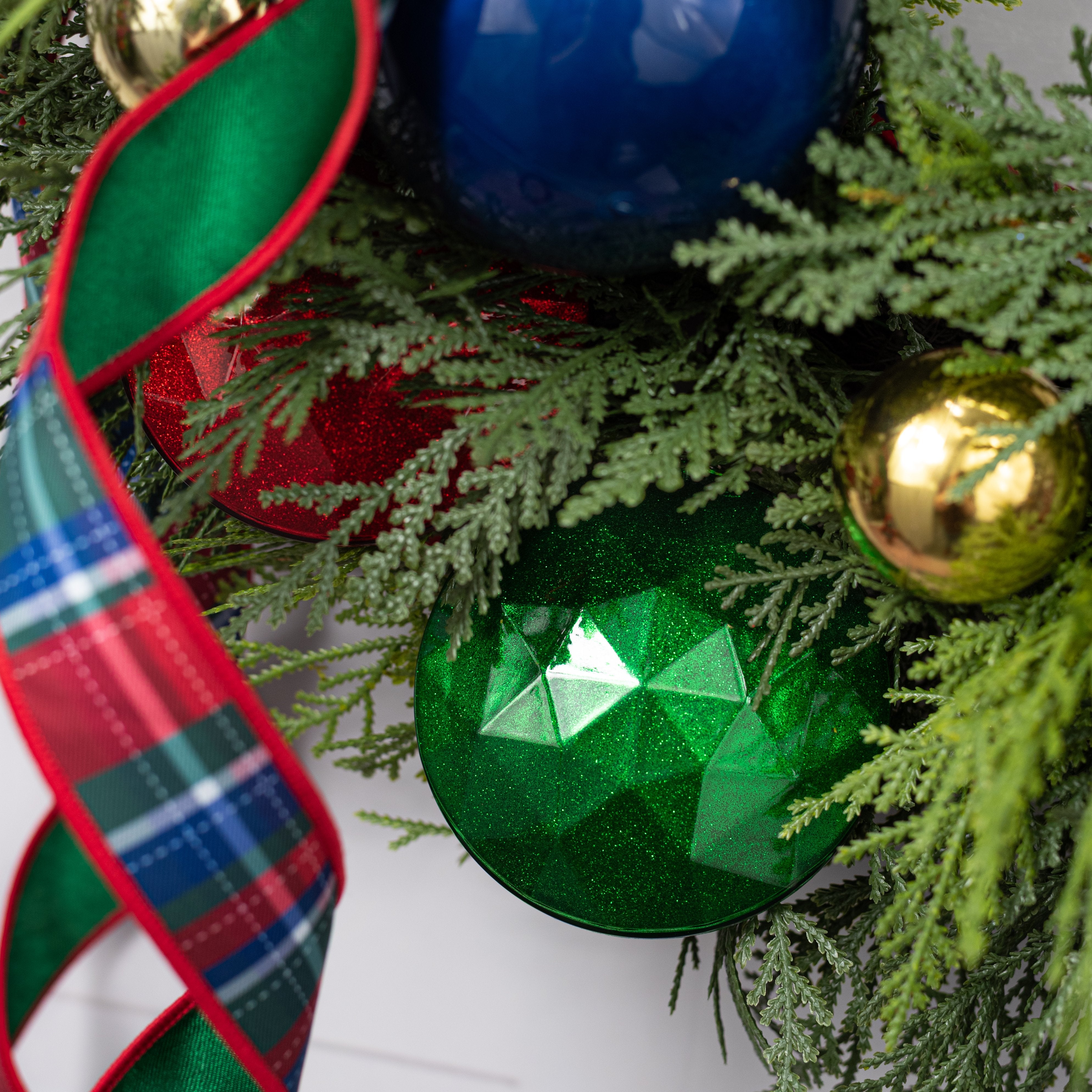 100mm Faceted Flat Round Gem Ornament: Glitter Inside Emerald Green Lifestyle Photo
