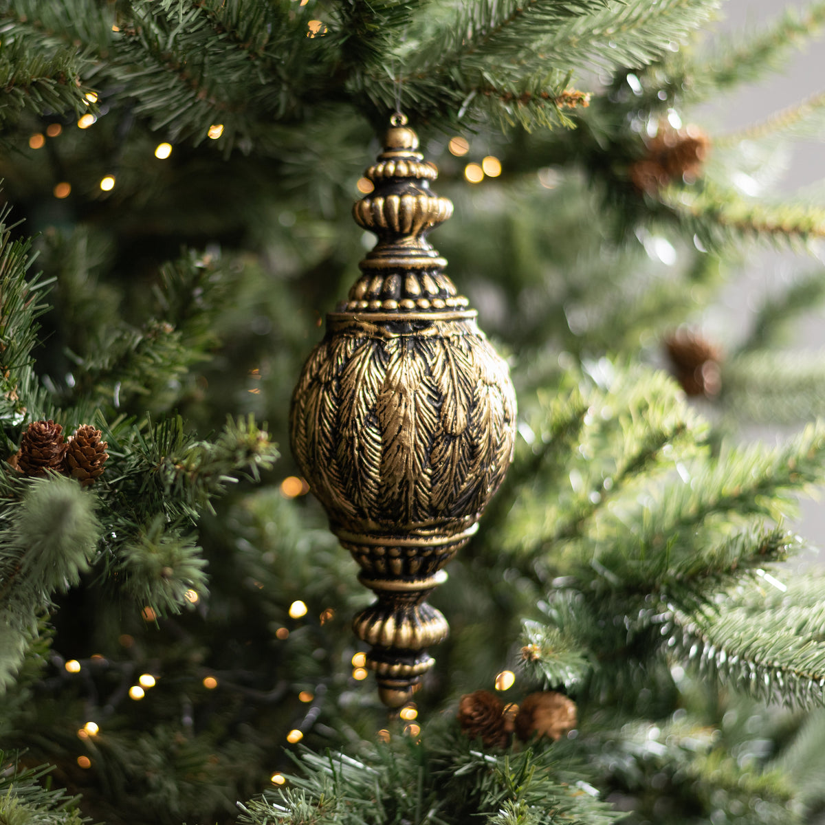 11" Antiqued Feather Finial Ornament: Black & Gold Lifestyle Photo