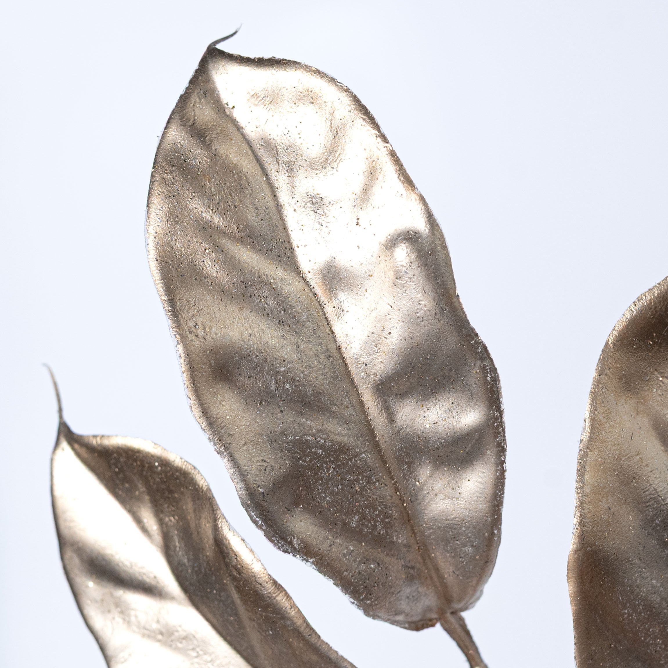 24" Metallic Magnolia Leaves & Twigs Spray: Champagne Gold Lifestyle Photo