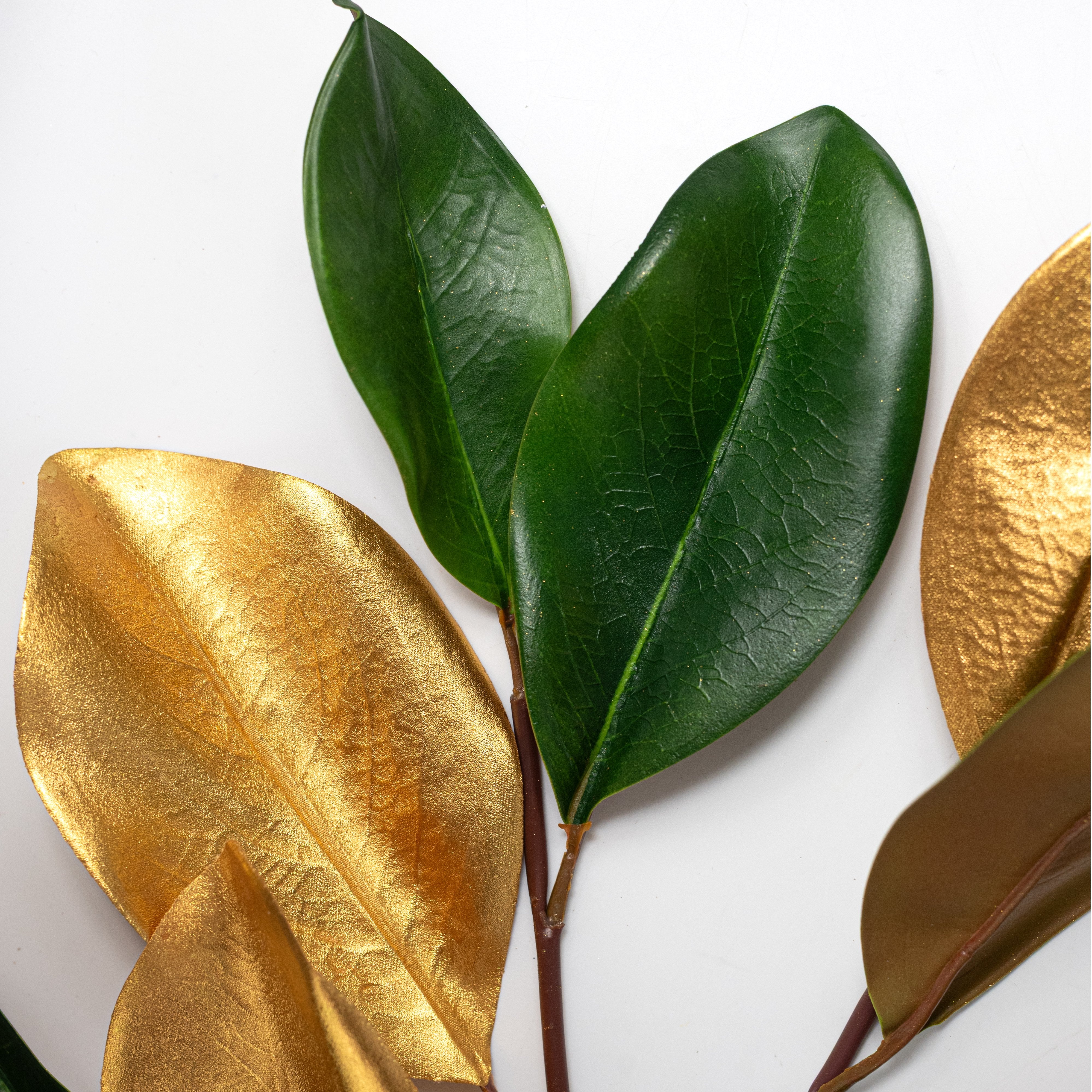 33" Artificial Magnolia Leaves Stem: Green & Metallic Gold Lifestyle Photo