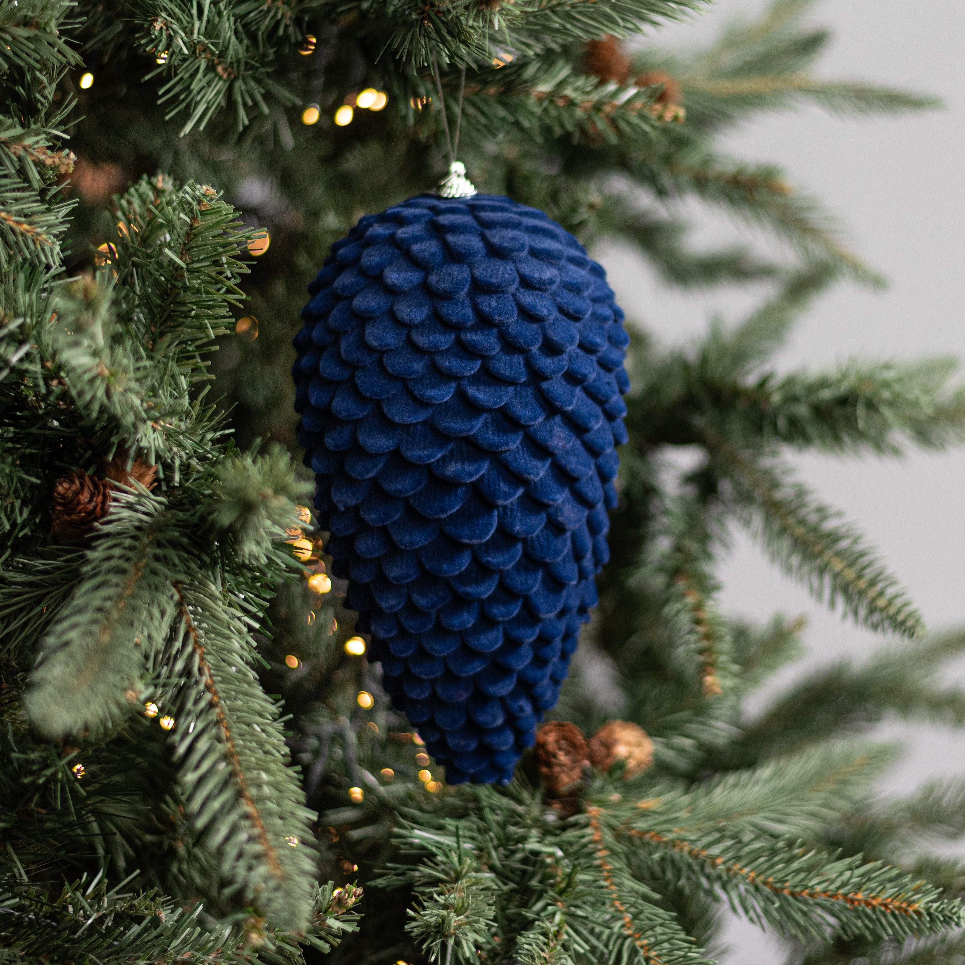 9.5" Flocked Pinecone Ornament: Dark Blue Lifestyle Photo
