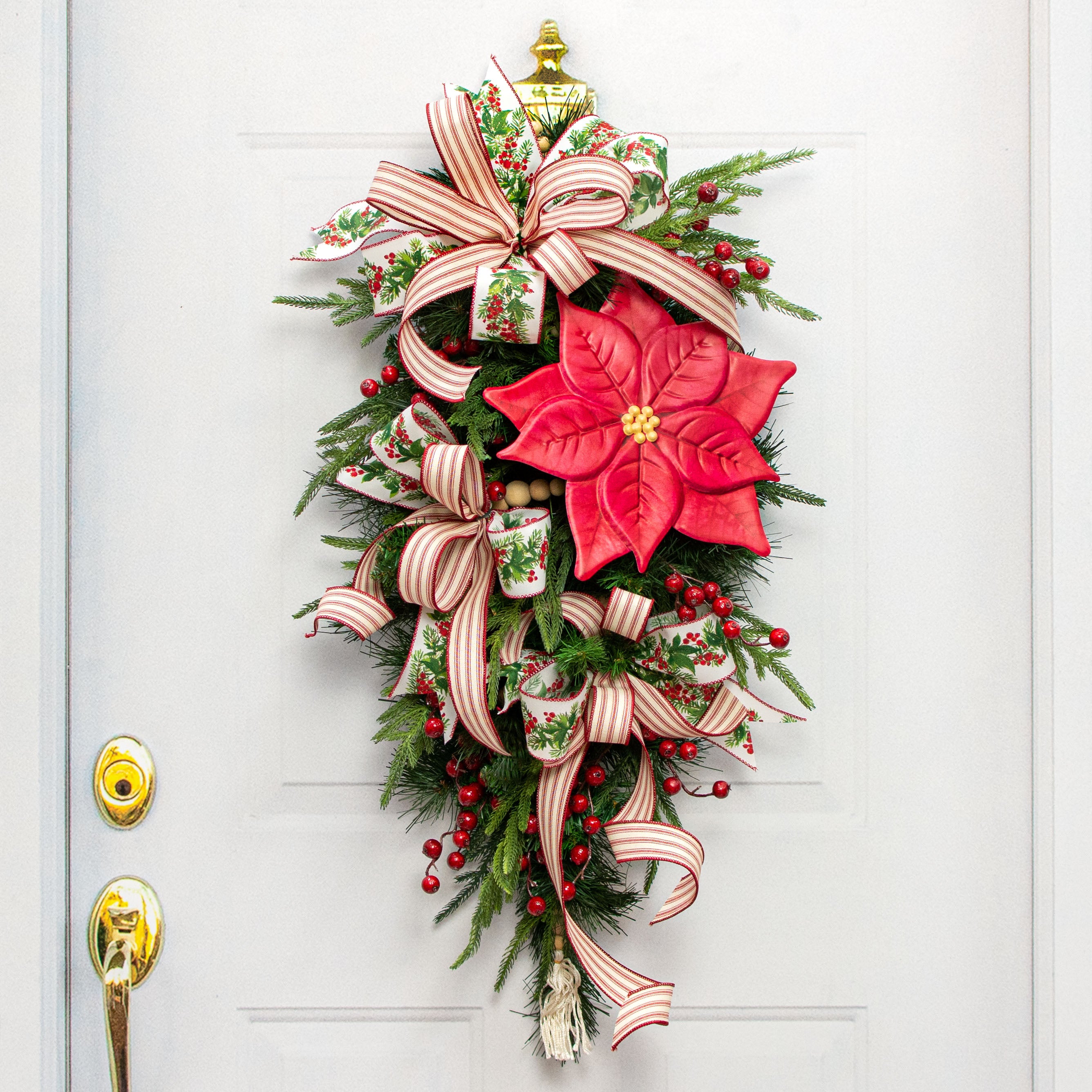 12" Embossed Metal Hanger: Red Poinsettia Lifestyle Photo