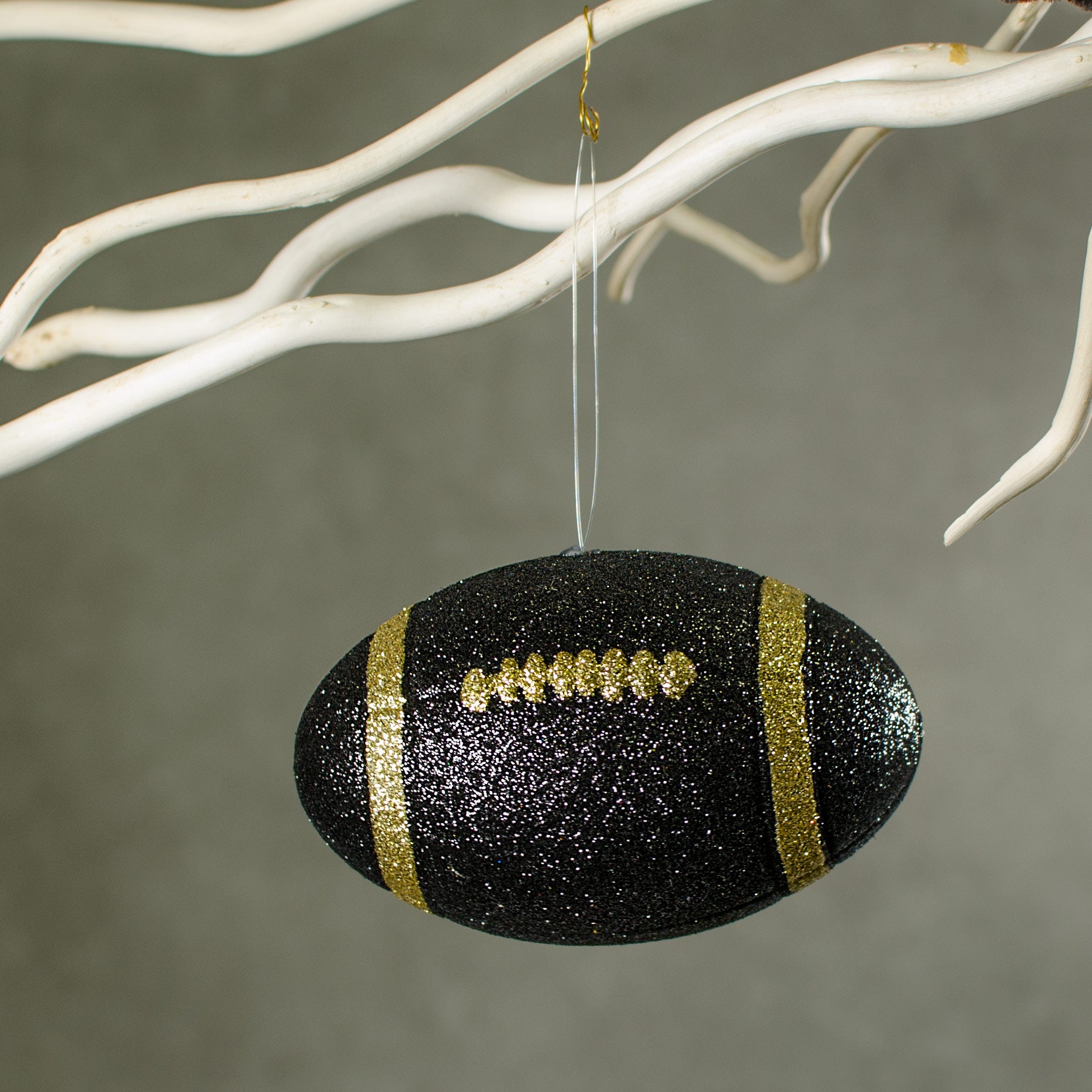 4.5" Metallic Glitter Football Ornament: Black & Gold Lifestyle Photo