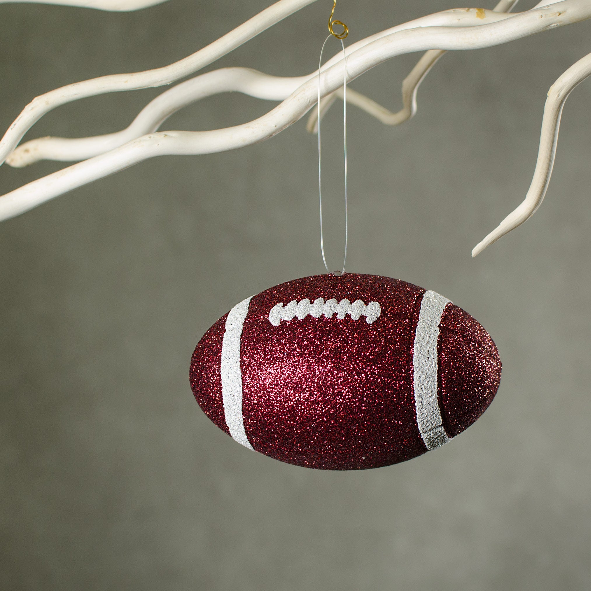 4.5" Metallic Glitter Football Ornament: Maroon & White Lifestyle Photo