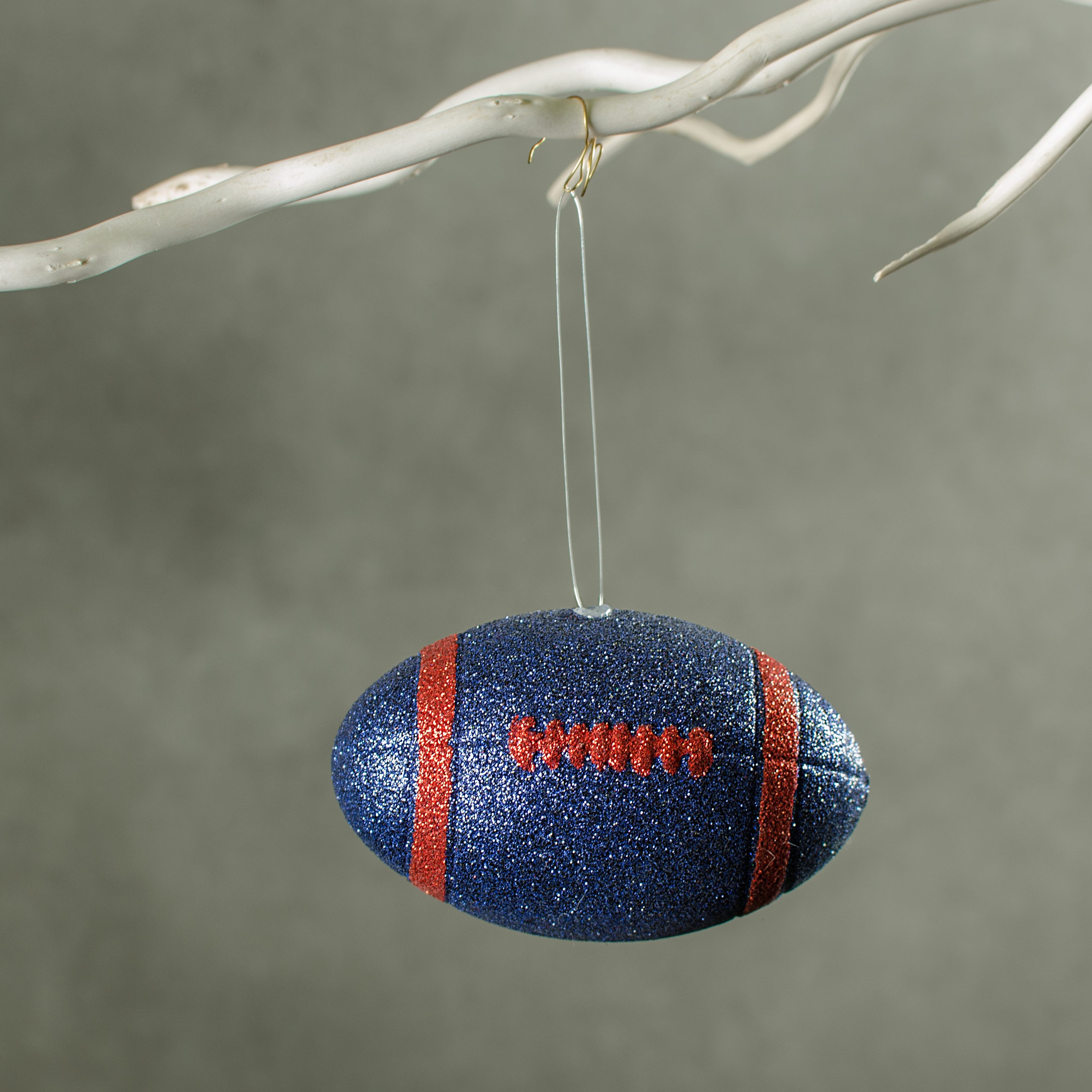 4.5" Metallic Glitter Football Ornament: Navy Blue & Red Lifestyle Photo