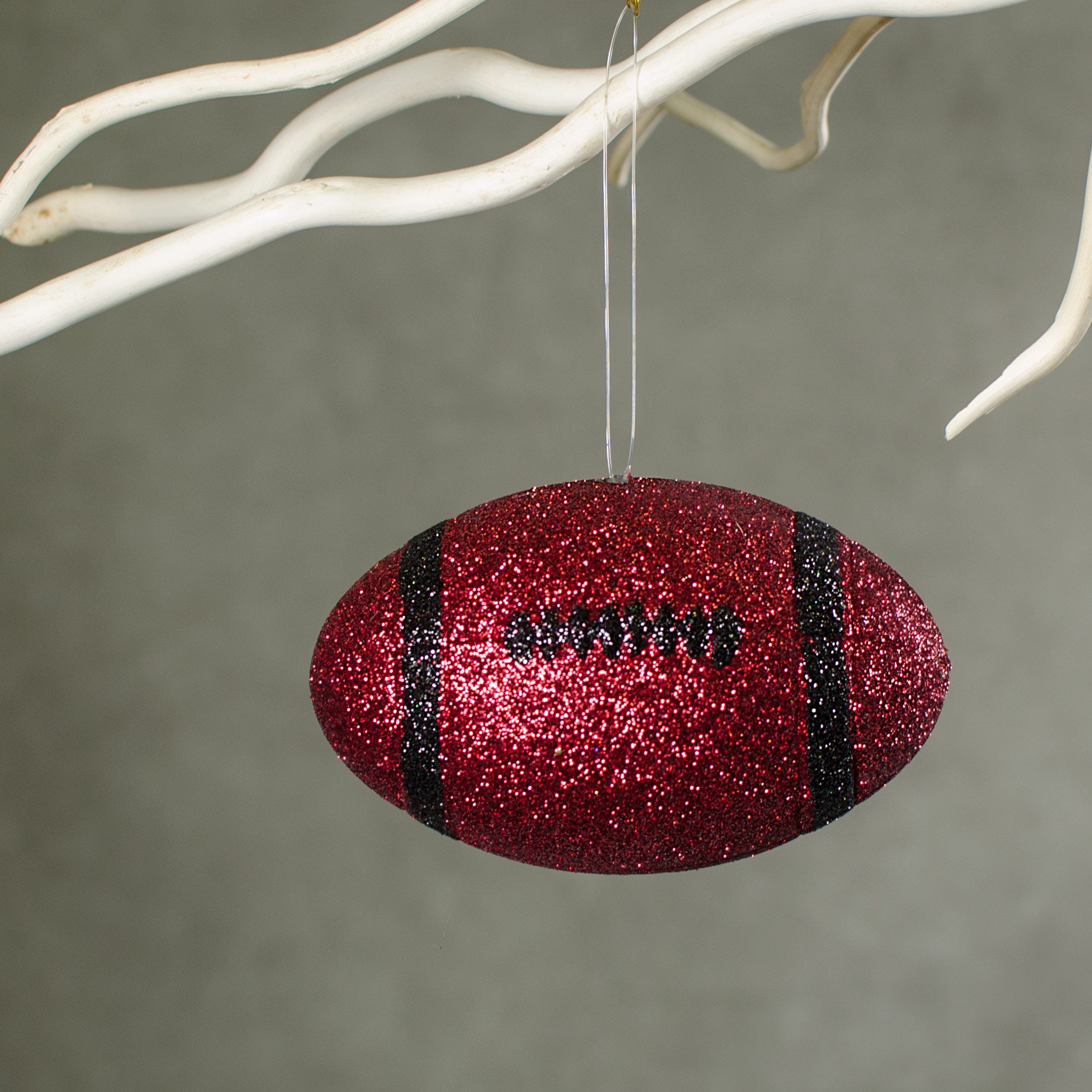 4.5" Metallic Glitter Football Ornament: Red & Black Lifestyle Photo