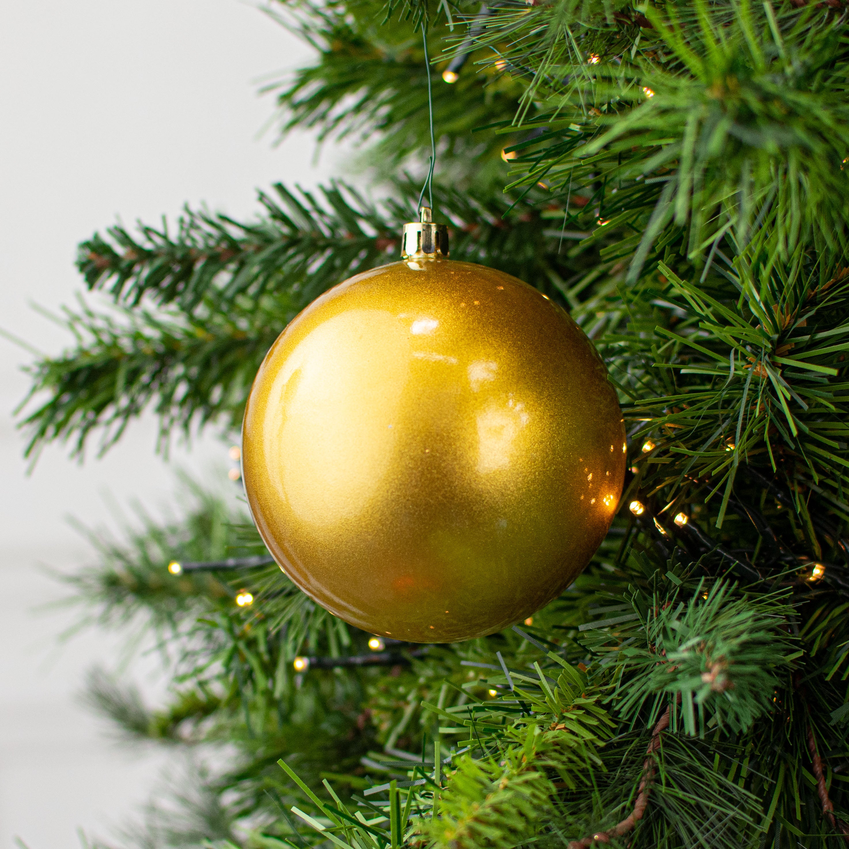 100MM Plastic Ball Ornament: Candy Apple Gold (Set of 4) Lifestyle Photo