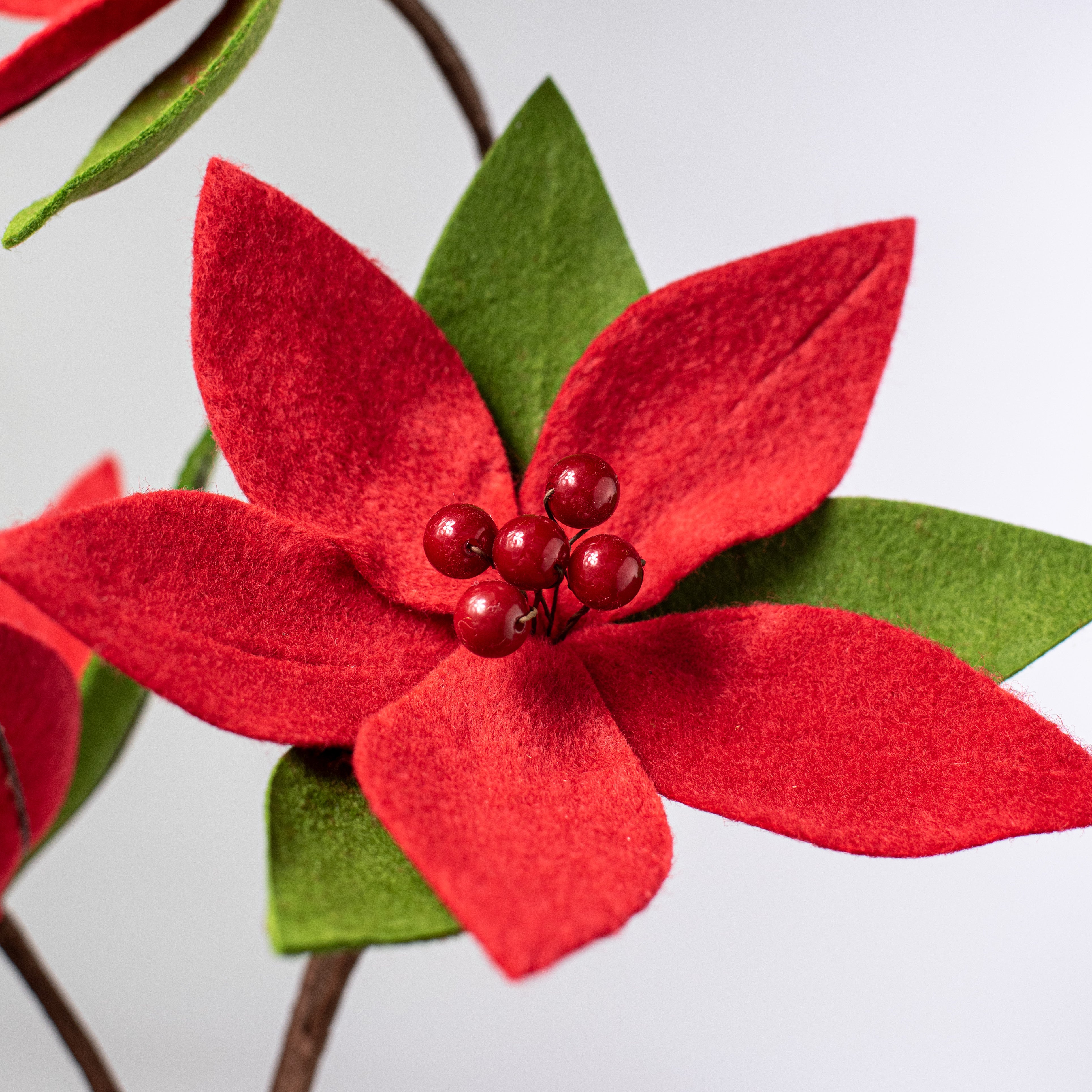 27" Poinsettia Stem: Red & Green Lifestyle Photo