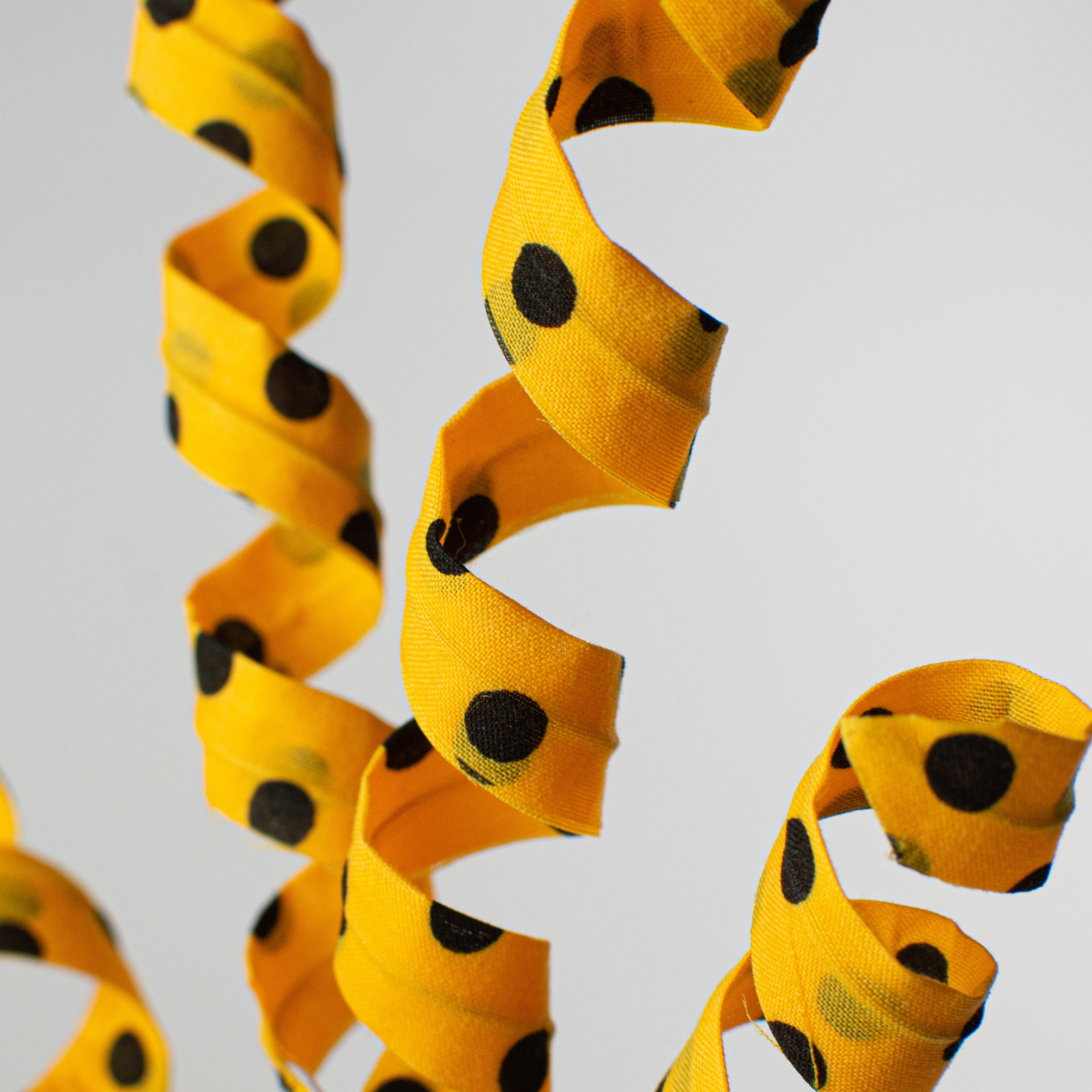 16" Polka Dot Curly Pick: Yellow & Black Lifestyle Photo