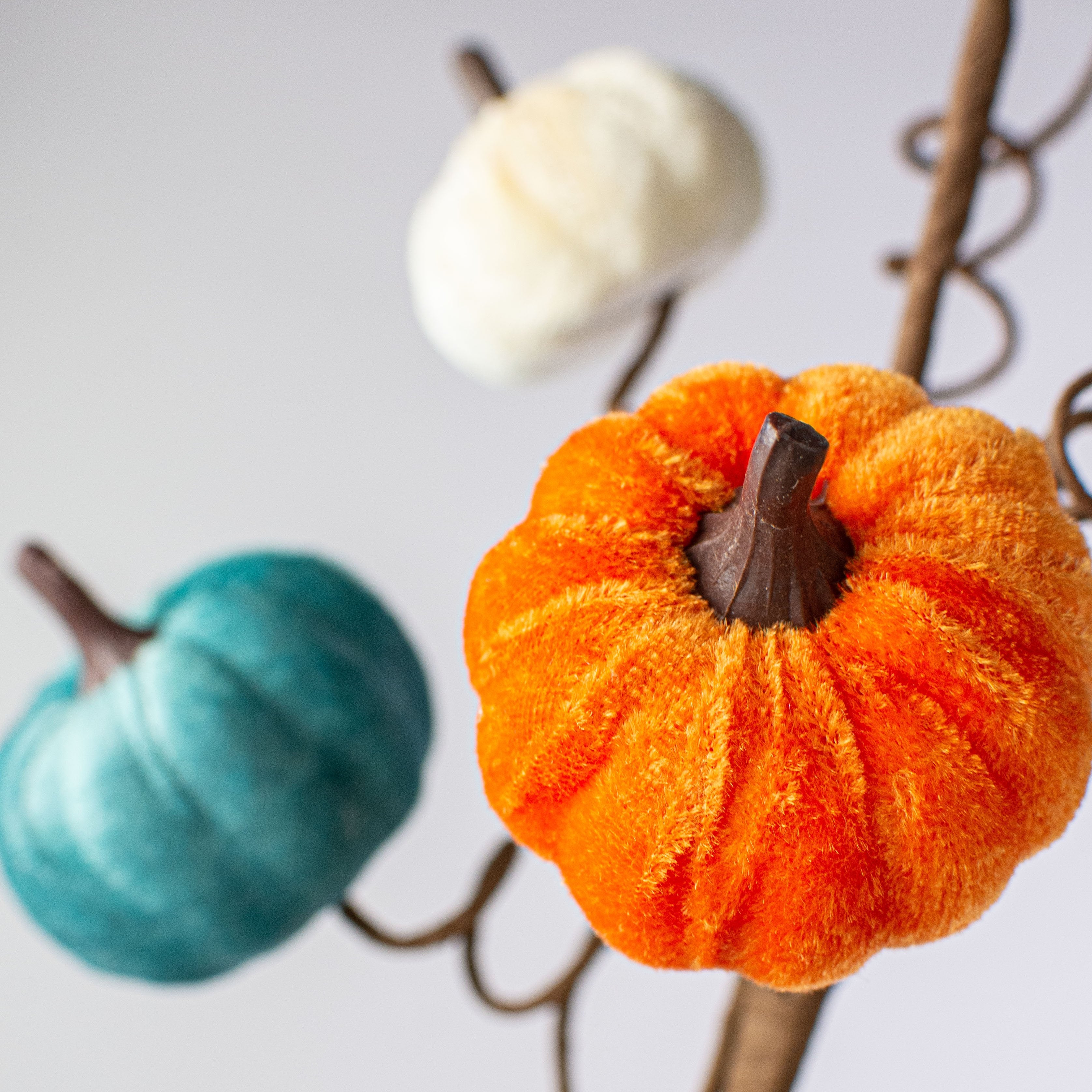 23" Velvet Pumpkin Spray: Teal, Orange & Cream Lifestyle Photo