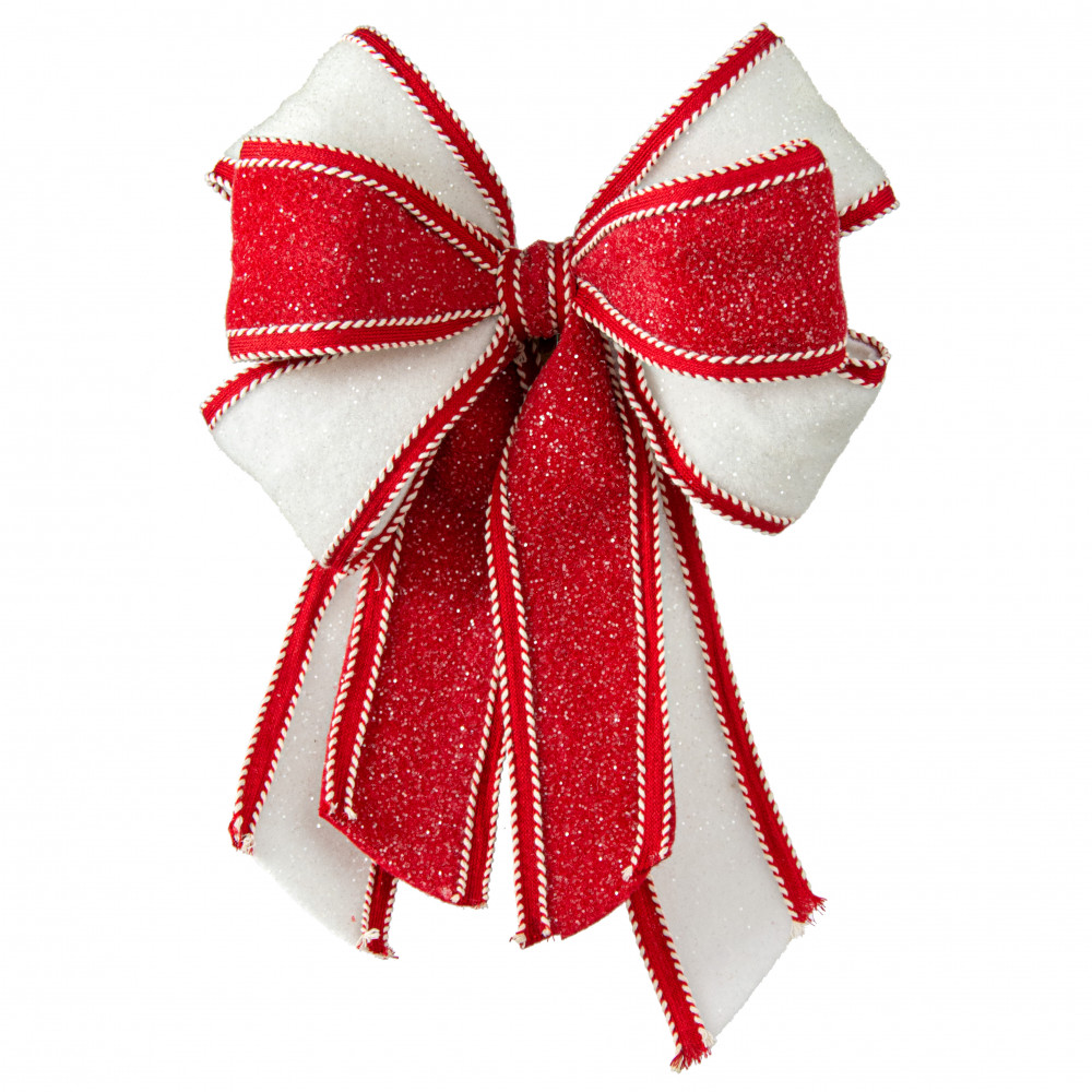 A bow of red curling ribbon with snowflakes as a frame. JPG